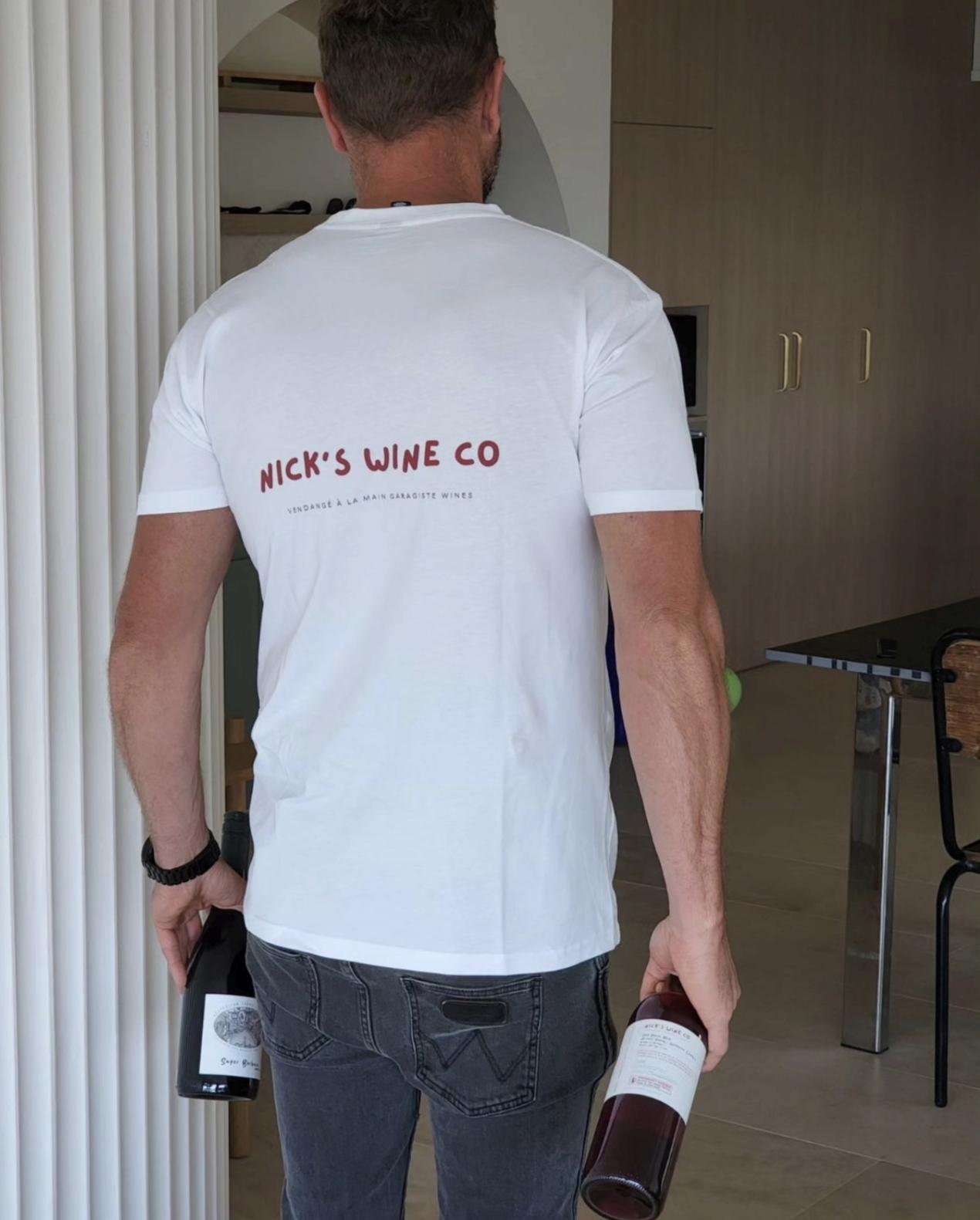 Nick carrying two earlier wine releases while wearing a Nick's Wine Co. shirt